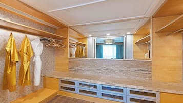 A modern bathroom with a vanity, mirror, and built-in shelves.