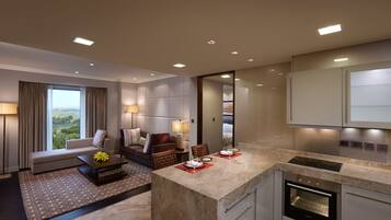 A modern hotel room with a living area, a dining space, and a kitchen.