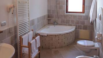 A bathroom with a bathtub, toilet, and sink.