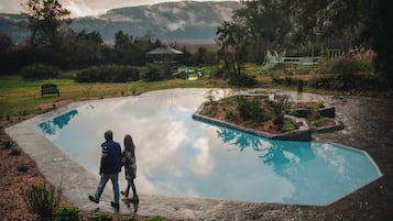 Seasonal outdoor pool, open 10:00 AM to 9:00 PM, pool umbrellas
