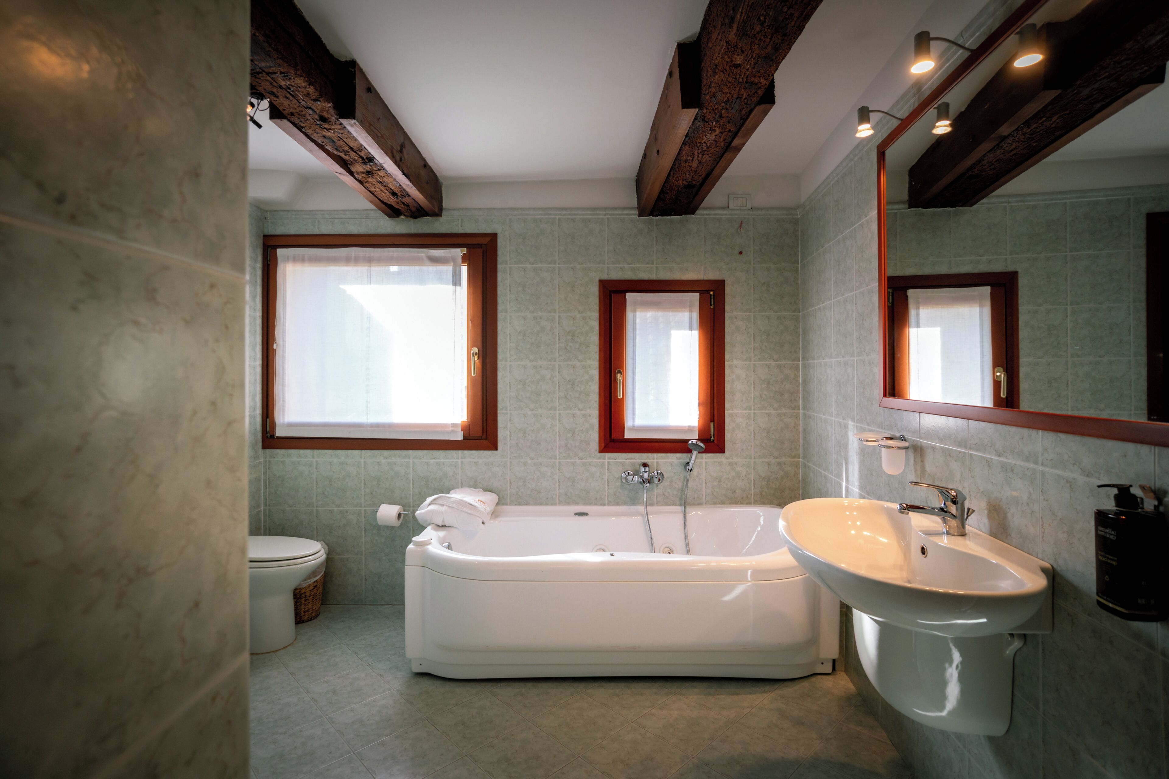 A bathroom with a freestanding bathtub, a sink, and a toilet.