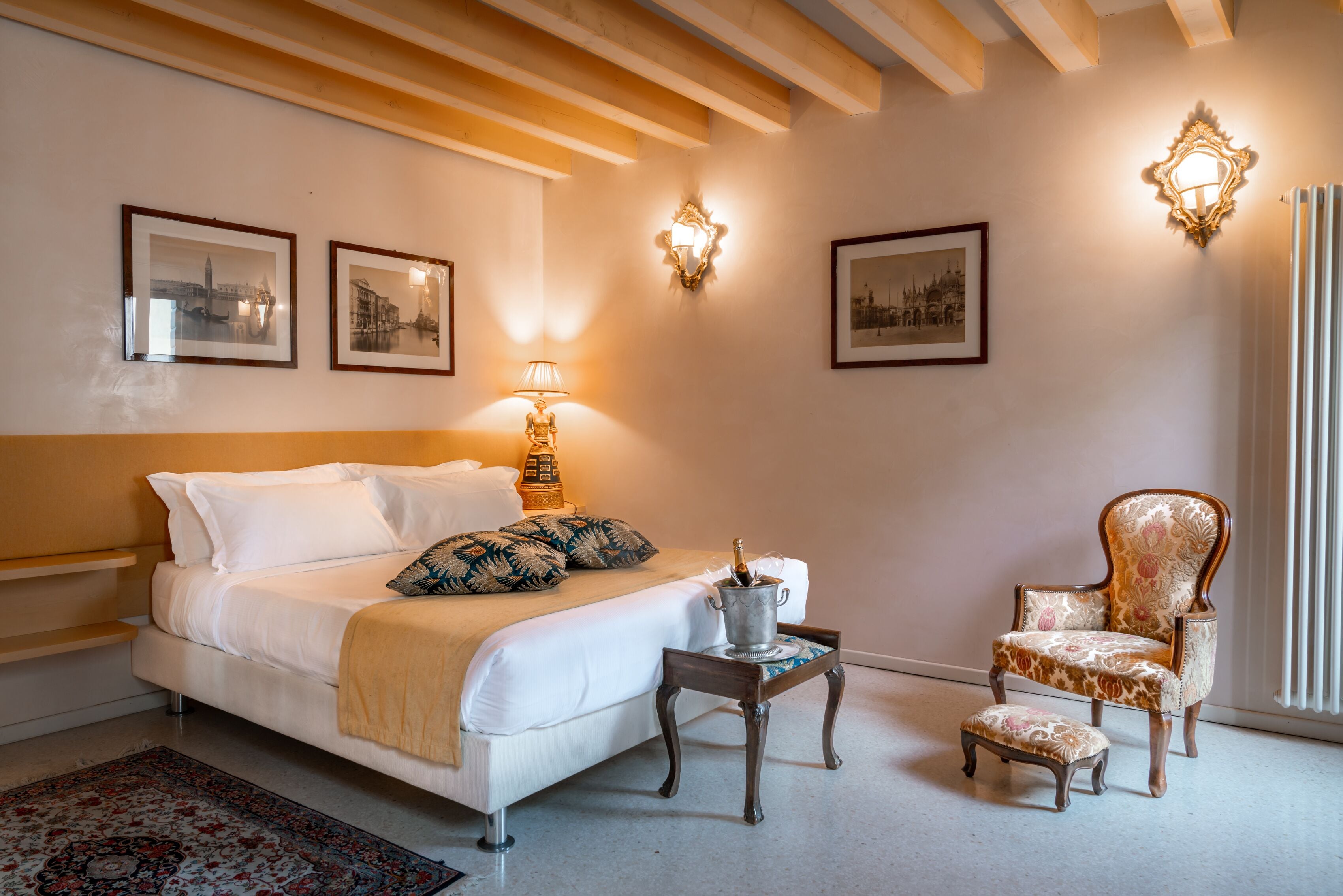 Une chambre à coucher comprenant un lit, une chaise, une table de chevet et des lampes fixées au mur.