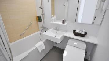 A modern bathroom with a bathtub, a sink, and a toilet. There is a towel rack and a shelf with toiletries.
