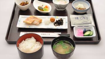 A tray with various Japanese dishes including sushi, rice, and soup.