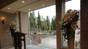 A church interior with a wooden lectern, altar, and a cross. - Mito Keisei Hotel (Mito)