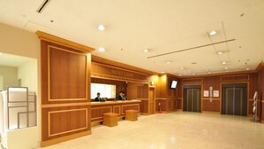 A spacious lobby with a reception desk labeled "FRONT CLAY," two elevators, and a tiled floor. - Mito Keisei Hotel (Mito)