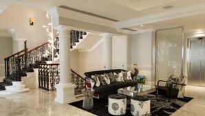 A spacious living area with a black sofa, a glass coffee table, and a black and white patterned rug. - The Ampersand Hotel - Small Luxury Hotels of the World (London)