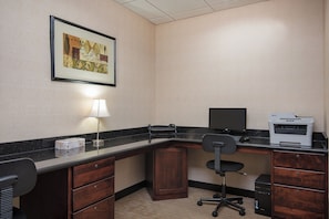 A hotel office with a desk, chair, printer, and a framed picture on the wall. - Holiday Inn Express & Suites Lafayette East by IHG (Lafayette)