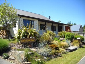 A building with a sign reading 'Cifti Peak View' surrounded by various plants and a clear sky. - Criffel Peak View B&B and Apartment (Wanaka)