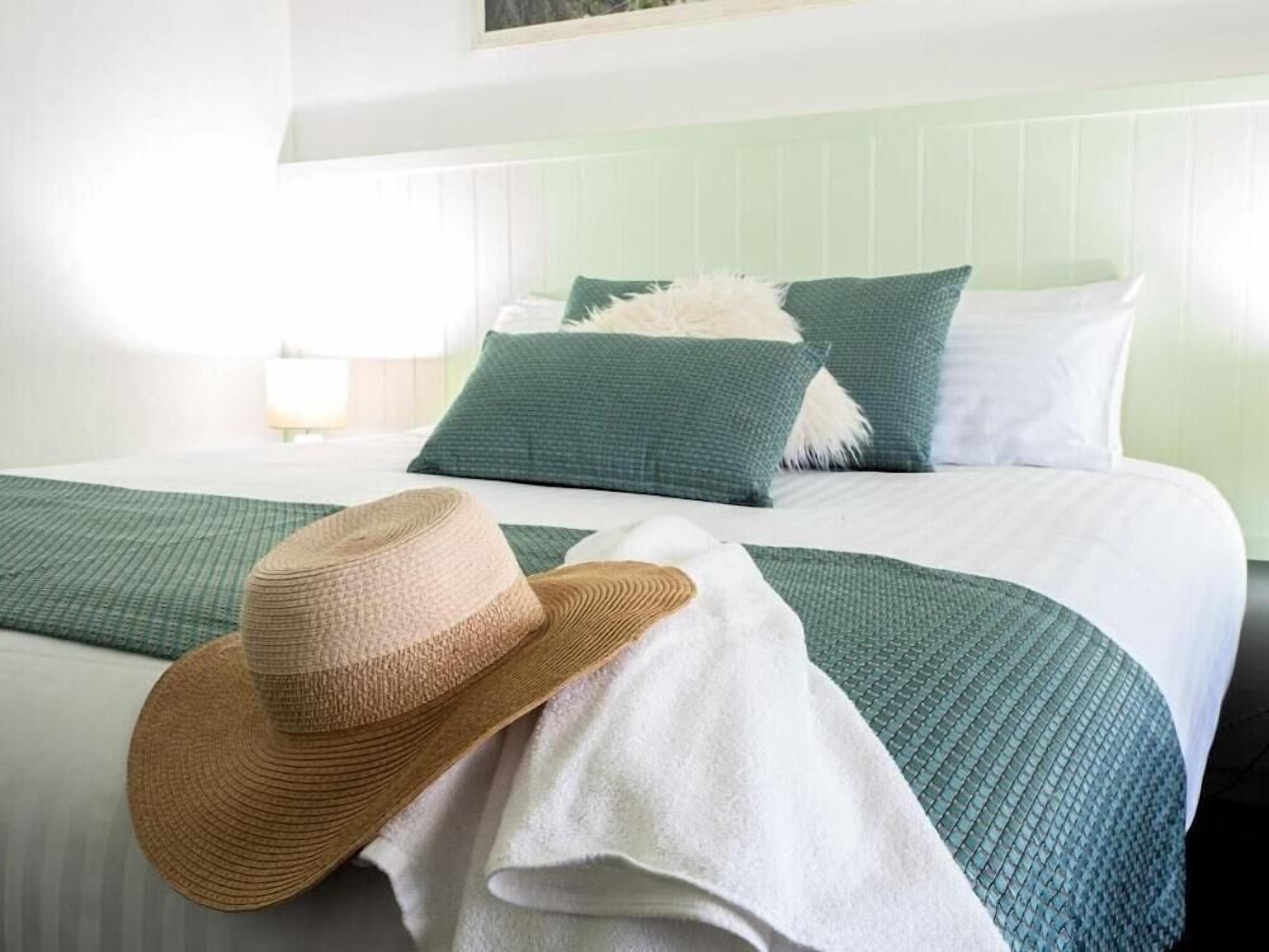 Premium bedding, desk, laptop workspace, blackout drapes