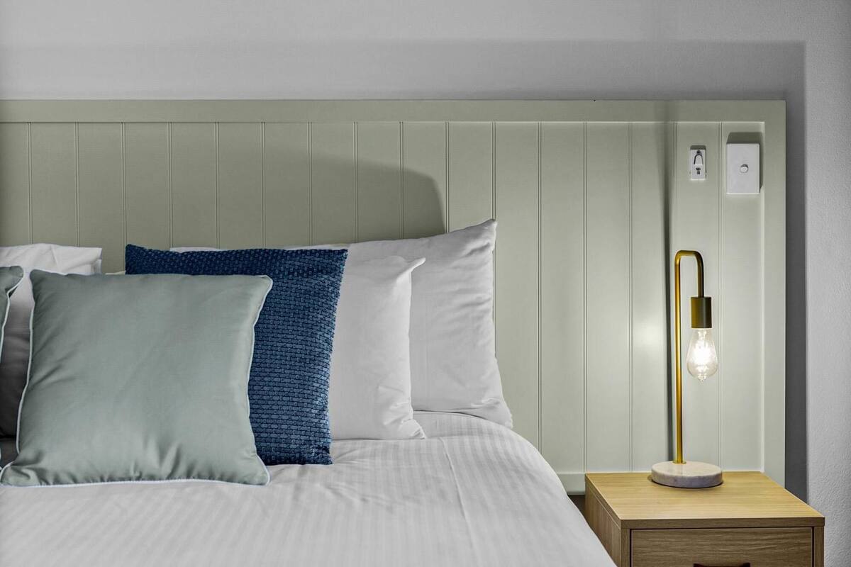 Premium bedding, desk, laptop workspace, blackout curtains