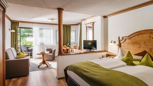 A hotel room with a bed, a desk, a chair, and a television. - Haymon (Seefeld in Tirol)