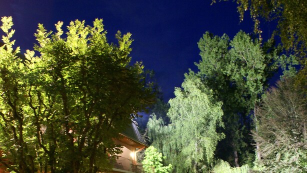 A garden pathway leading to a building with outdoor seating and lanterns. - Hotel de la Gaichel (Habscht)