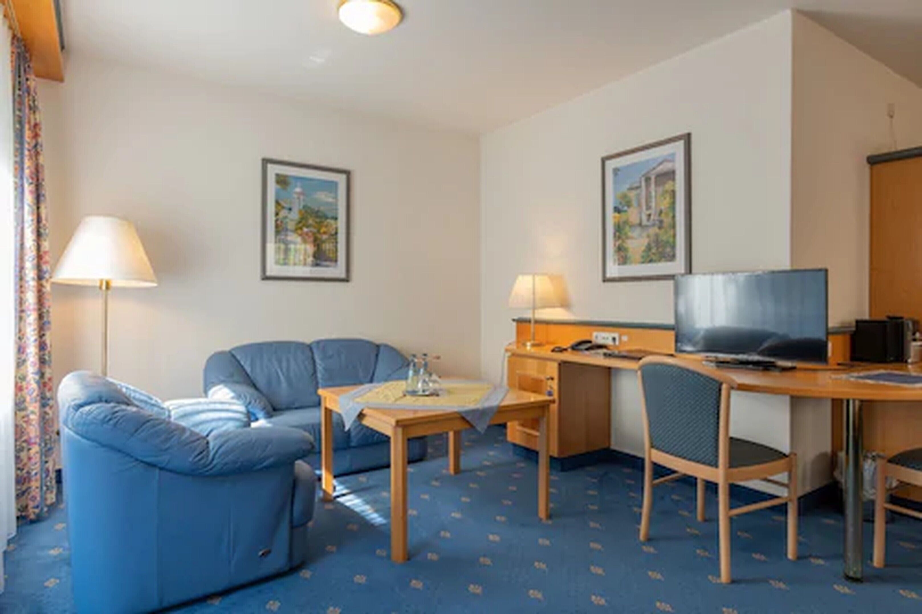 deluxe double room | living area | 50-inch flat-screen tv with digital channels