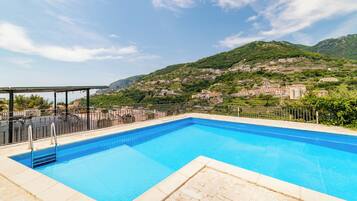 Seasonal outdoor pool, open 11:00 AM to 7:00 PM, pool umbrellas