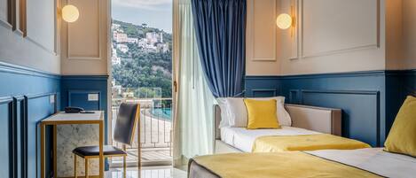 A hotel room with a balcony, a desk, and two beds.