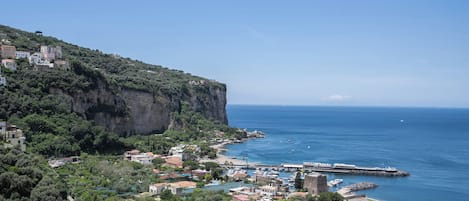 A coastal town with buildings on a hillside overlooking the sea.