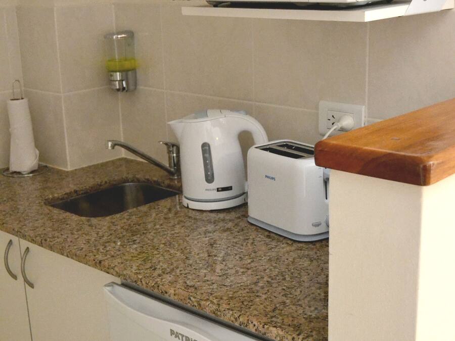 A kitchen with a microwave, toaster, and coffee maker on the countertop.