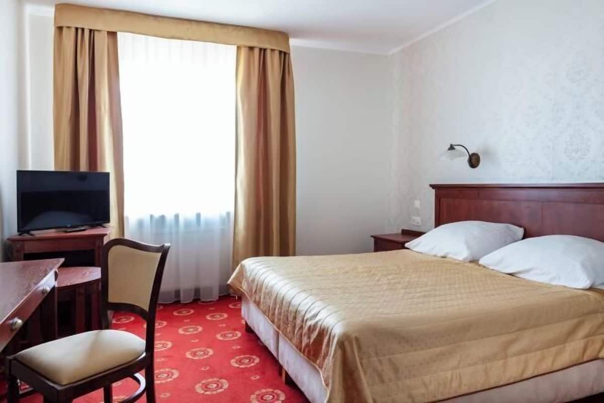 Hypo-allergenic bedding, desk, laptop workspace, blackout curtains