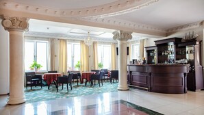A spacious lobby with a bar area, large windows, and a chandelier. - Anin Park Hotel (Warsaw)