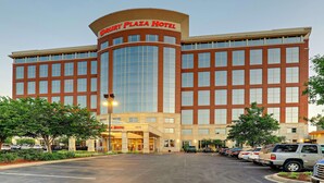 A large hotel with a curved facade, multiple floors, and a prominent entrance.