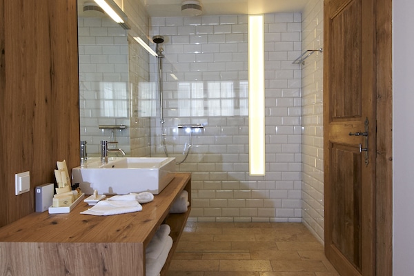 Shower, designer toiletries, hair dryer, bathrobes