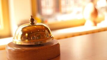 A wooden table with a glass dome object on top.
