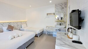 A hotel room with a large bed, a smaller bed, a bathroom with a marble vanity, and a TV mounted on the wall. - Saithong Resort (Sikao)