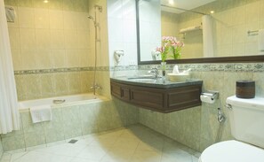 A modern bathroom with a bathtub, sink, and toilet.