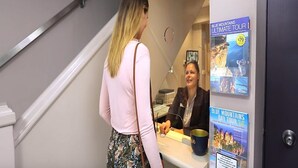 A reception desk with a sign for Blue Mountains Ultimate Tour. - The Maisonette (Potts Point)