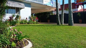 A motel with a covered outdoor area, a sign for 'Blue Motel', and a 'Maximum Clearance 2.5m' sign. - Blue Pelican Motel (Tweed Heads)
