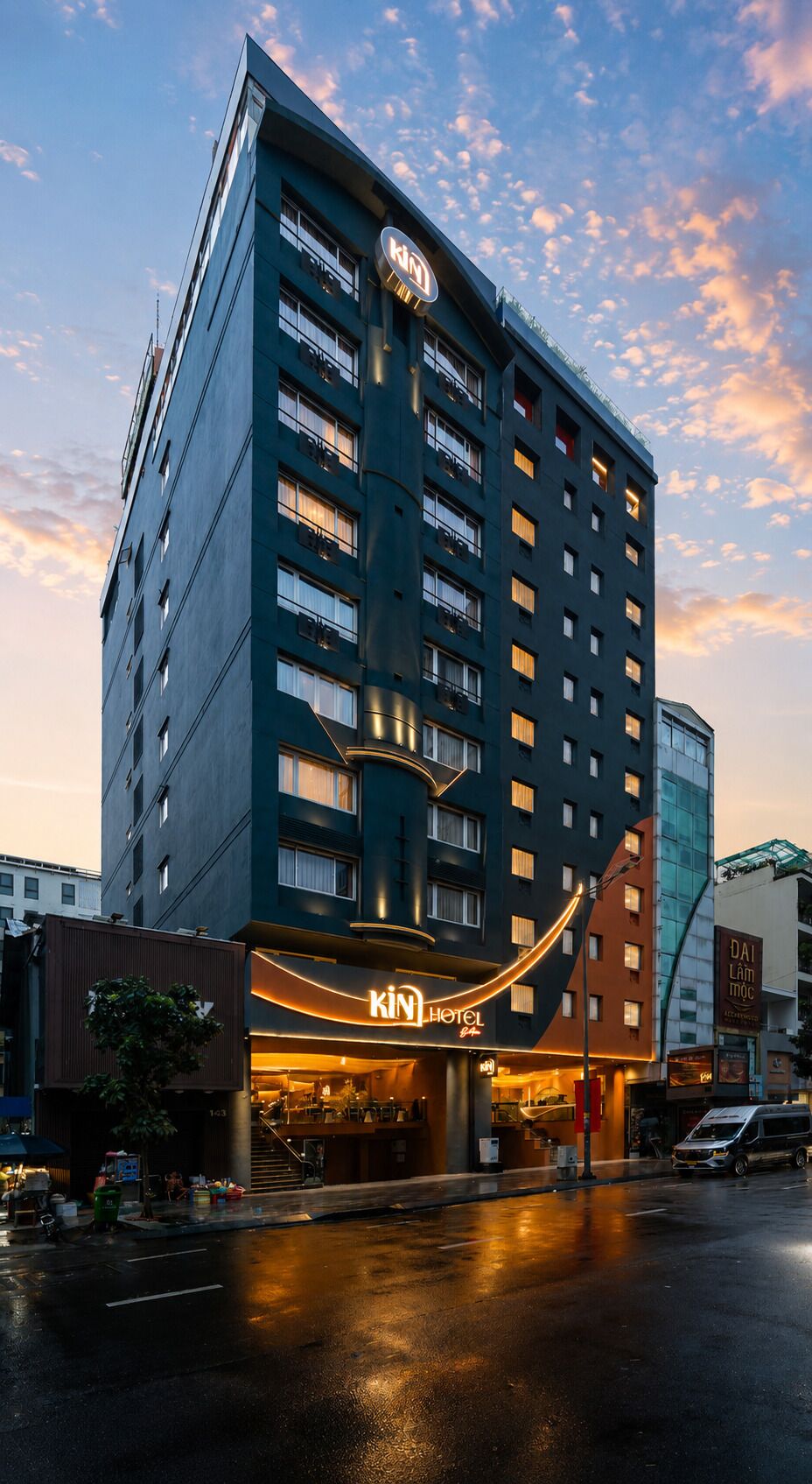 A multi-story hotel with a prominent sign for 'KINT HOTEL' and a visible entrance.