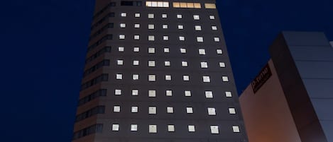 A high-rise hotel building with a prominent sign at the top reading 'ALMONT HOTEL'.
