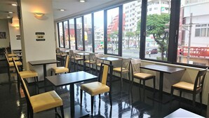 A restaurant with tables and chairs arranged for dining. - Smile Hotel Okinawa Naha (Naha)