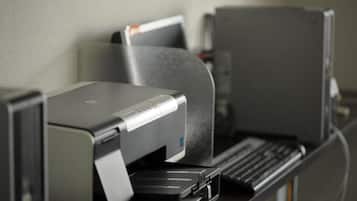 A printer and a computer monitor on a desk.