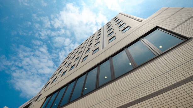 A modern building with a grid of windows and a tiled facade. - Smile Hotel Okinawa Naha (Naha)