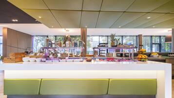 A modern breakfast bar with various food items and condiments.