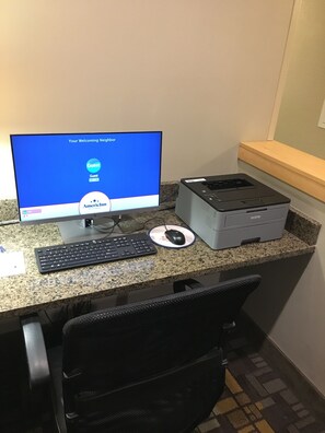 A computer desk with a monitor, keyboard, mouse, and printer. - AmericInn by Wyndham Fairfield (Fairfield)