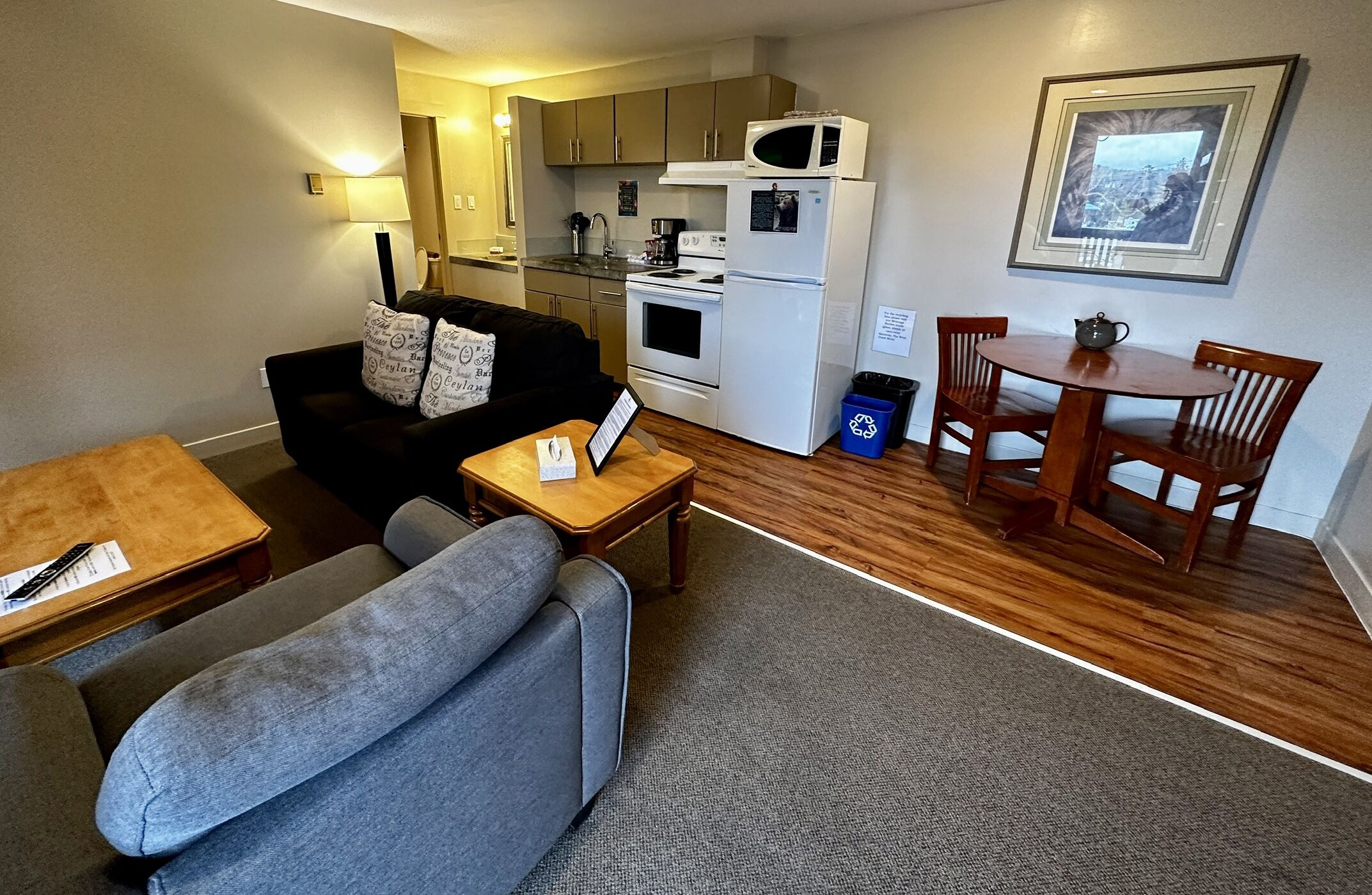 A compact living space with a kitchenette, a dining area, and a seating area.