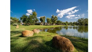 A serene landscape with a pond, grass, and large rocks. - TH Marina di Sibari - Baia degli Achei Village (Cassano allo Ionio)
