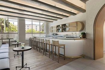 A poolside bar with seating and a view of the pool. at Live Oak, Charleston Historic District, a Tribute Portfolio Hotel