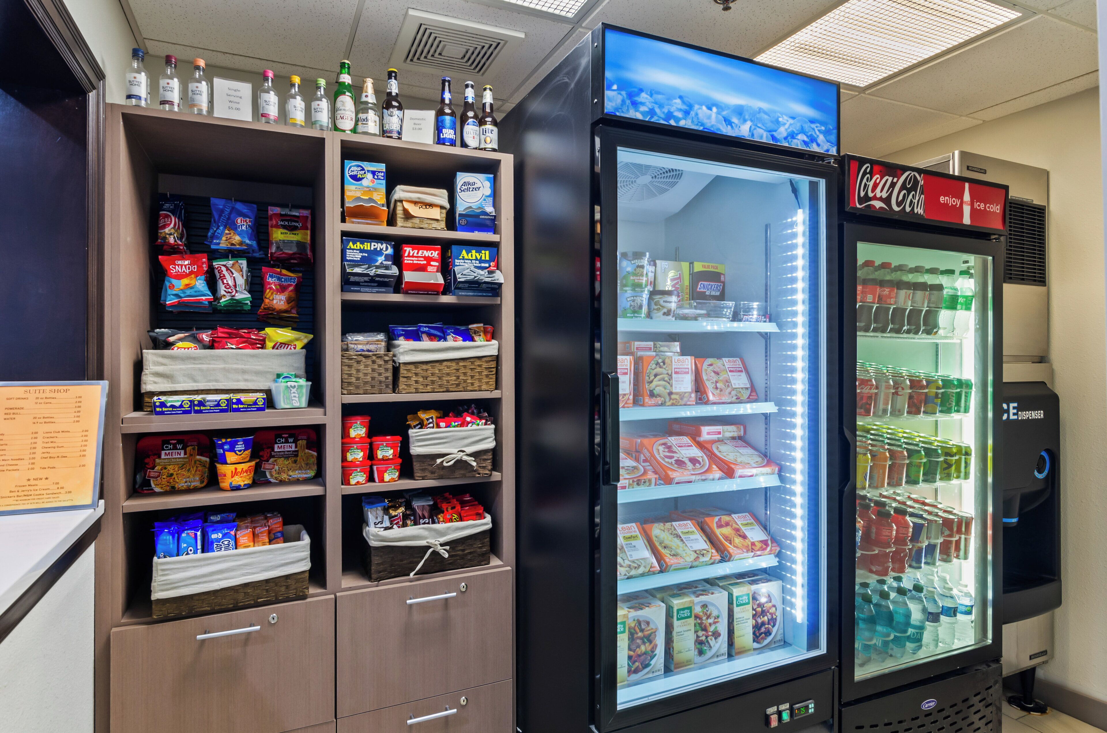 A vending machine stocked with snacks and beverages, including a Coca-Cola dispenser.