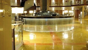 A spacious lobby with a central water feature, multiple floors, and a modern design. - Cumbria Spa&hotel (Ciudad Real)