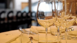 A table set with multiple wine glasses and a small glass with a spoon, indicating a dining setting. - Cumbria Spa&hotel (Ciudad Real)
