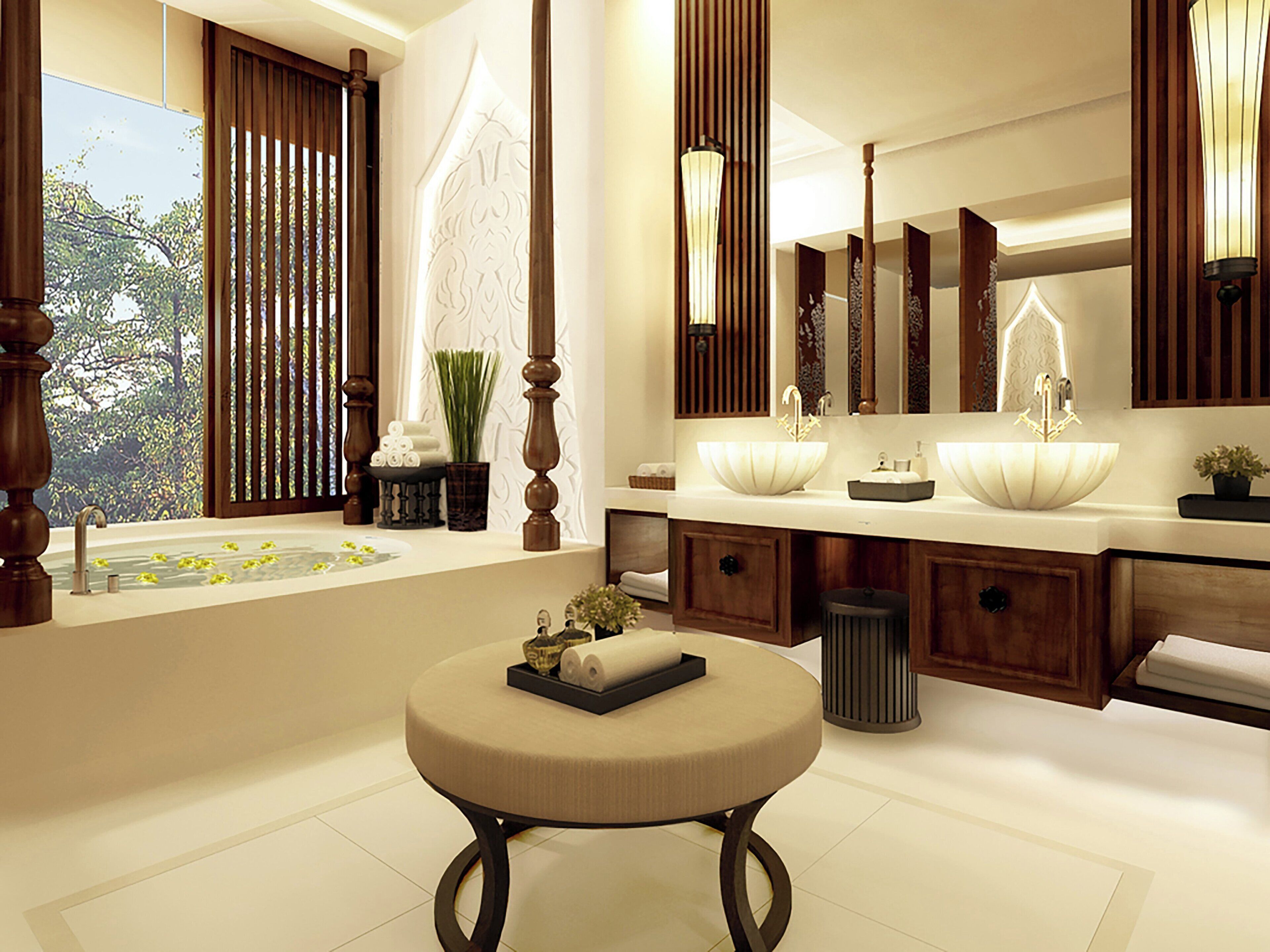 A modern bathroom with a large bathtub, two sinks, and a vanity with a mirror.