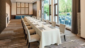 A conference room with a long table, chairs, and a view of the outdoors. - Holiday Inn Nanyang by IHG (Nanyang)