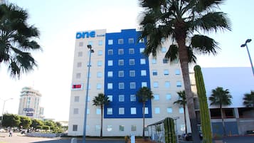 Welcome to One Hotel, a stylish building with a modern design and a tropical ambiance.