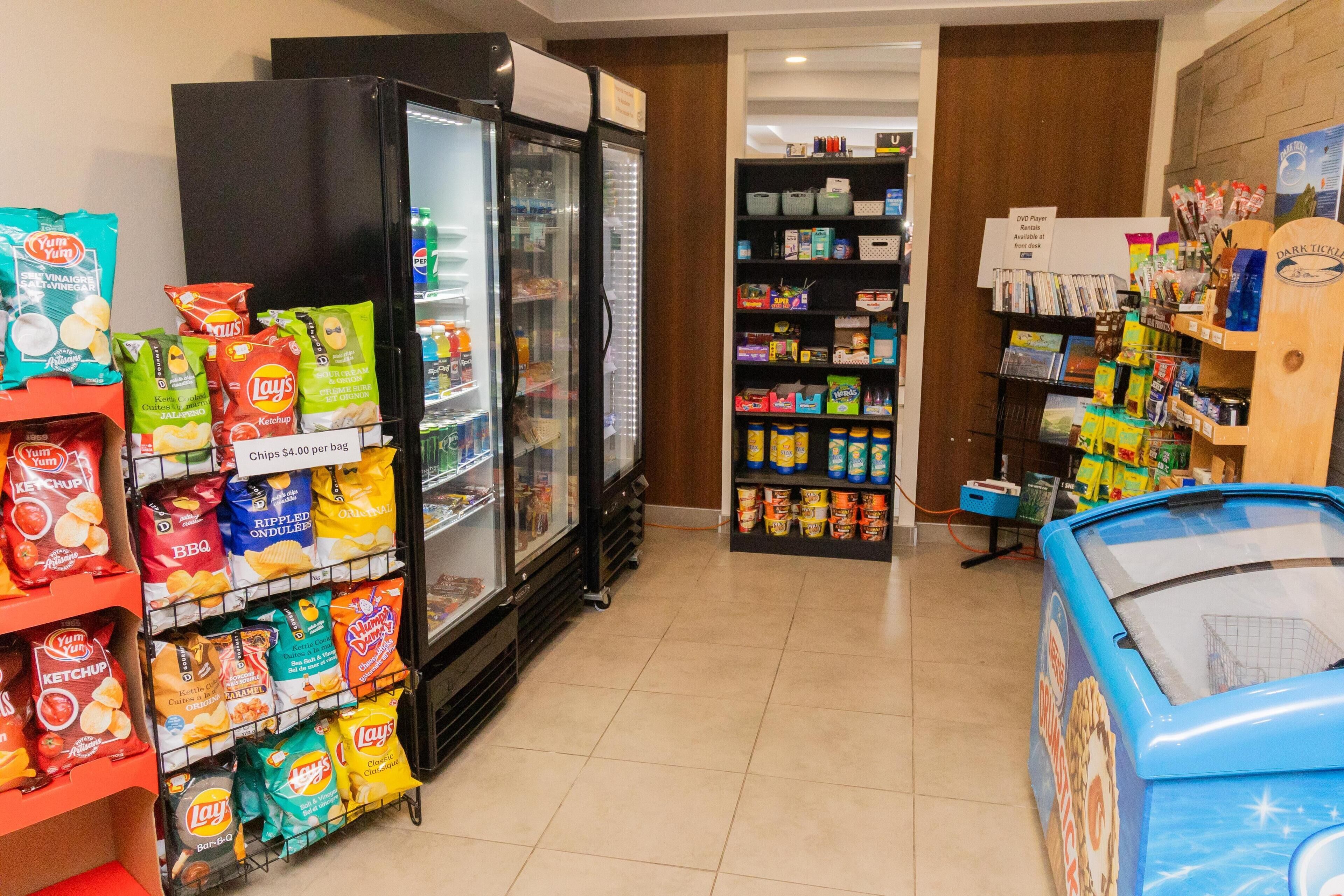 A grocery store with refrigerated freezers, snack aisles, and a freezer section.