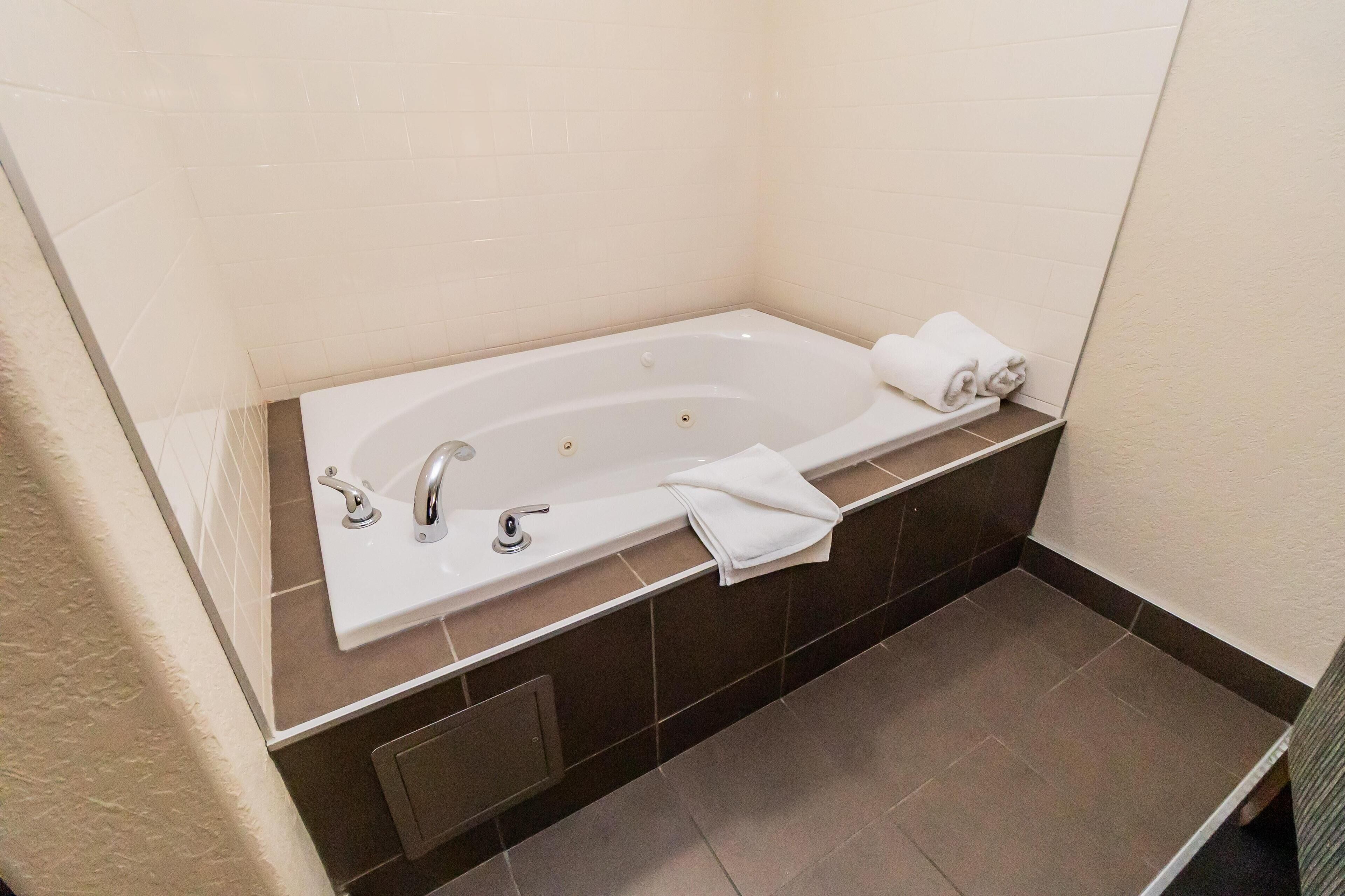 A modern bathroom with a freestanding bathtub, a sink, and a towel rack.