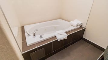 A modern bathroom with a freestanding bathtub, a sink, and a towel rack.